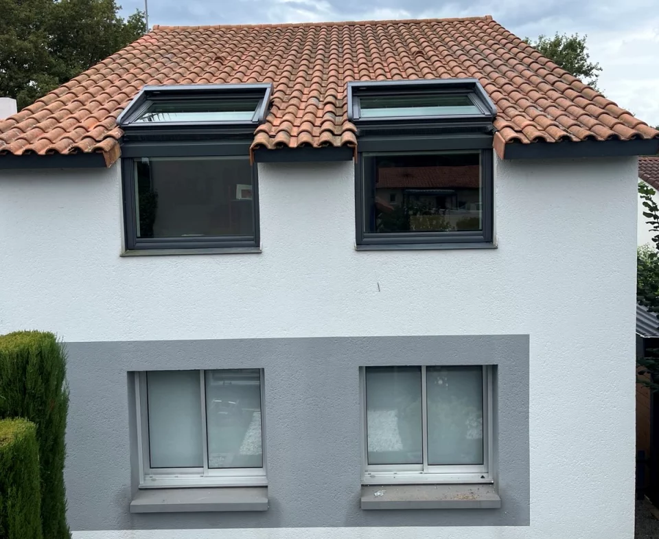 Artim Menuisier Cholet VELUX Signal 2024 09 05 184253 002 vue extérieure d'une maison avec tuiles avec 2 fenêtres de toit VELUX à l'étage